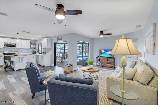 1416 SW 52nd Ter, Cape Coral, FL 33914 - living room featuring ceiling fan, light wood-style floors, and recessed lighting