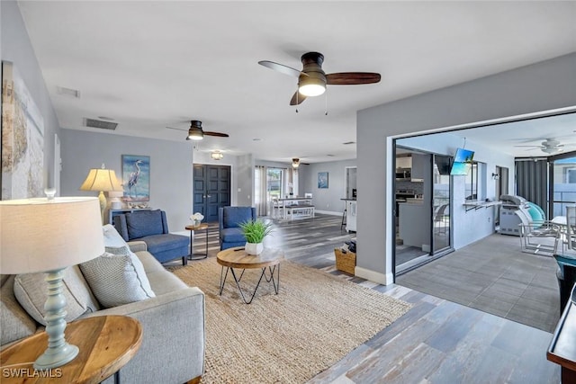 1416 SW 52nd Ter, Cape Coral, FL 33914 - living room featuring ceiling fan, wood finished floors, and baseboards