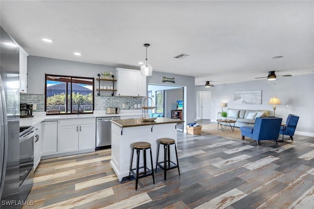 1416 SW 52nd Ter, Cape Coral, FL 33914 - kitchen with stainless steel appliances, open floor plan, light wood-style flooring, a ceiling fan, and recessed lighting