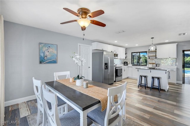 1416 SW 52nd Ter, Cape Coral, FL 33914 - dining room with ceiling fan, light wood-style floors, recessed lighting, and baseboards