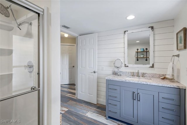 1416 SW 52nd Ter, Cape Coral, FL 33914 - full bathroom featuring wood finished floors, a stall shower, vanity, and wooden walls