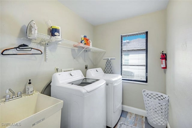 1416 SW 52nd Ter, Cape Coral, FL 33914 - laundry area with washer and dryer, baseboards, and light wood finished floors