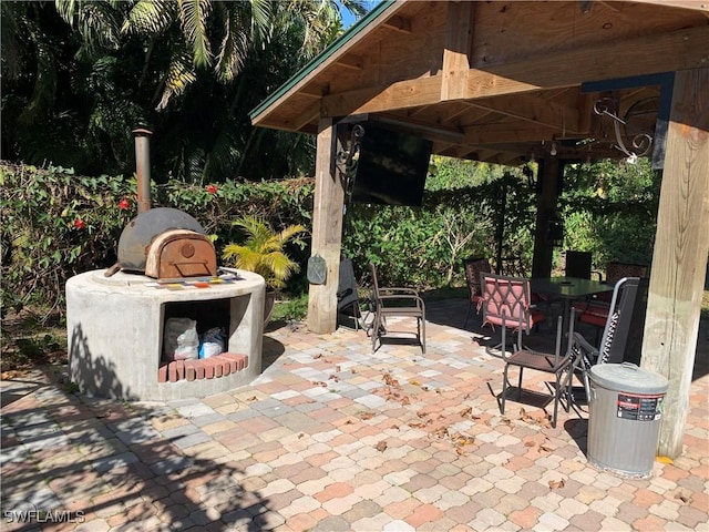 view of patio / terrace featuring outdoor dining area and a gazebo