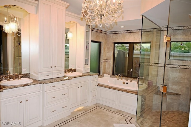 full bath with a chandelier, a garden tub, a sink, and double vanity