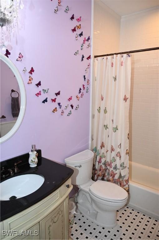 full bath with shower / tub combo, vanity, toilet, and tile patterned floors