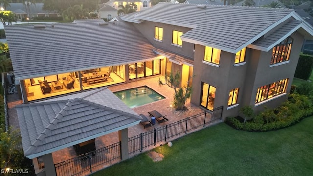 back of house with a fenced in pool, a lawn, a patio, fence, and stucco siding