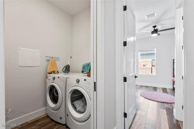 laundry room featuring visible vents, washer and dryer, wood finished floors, baseboards, and laundry area