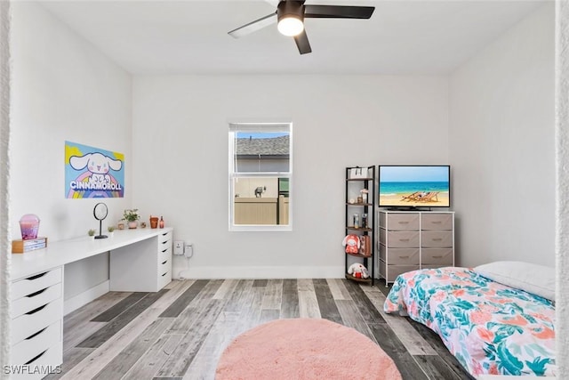 bedroom with baseboards, wood finished floors, and a ceiling fan