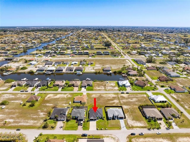 drone / aerial view with a residential view and a water view