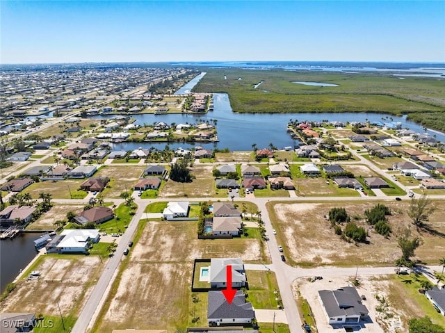 bird's eye view with a residential view and a water view