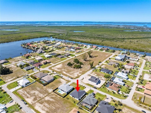 birds eye view of property with a water view and a residential view