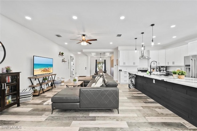 living room featuring visible vents, recessed lighting, and light wood-style flooring