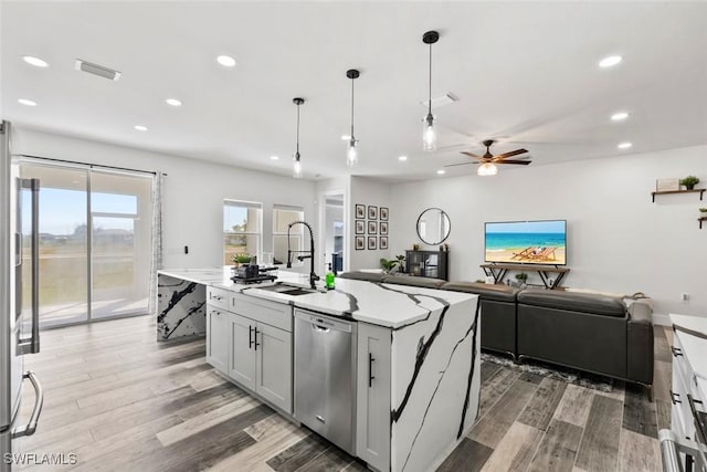 kitchen with visible vents, recessed lighting, light wood-style flooring, stainless steel appliances, and a sink