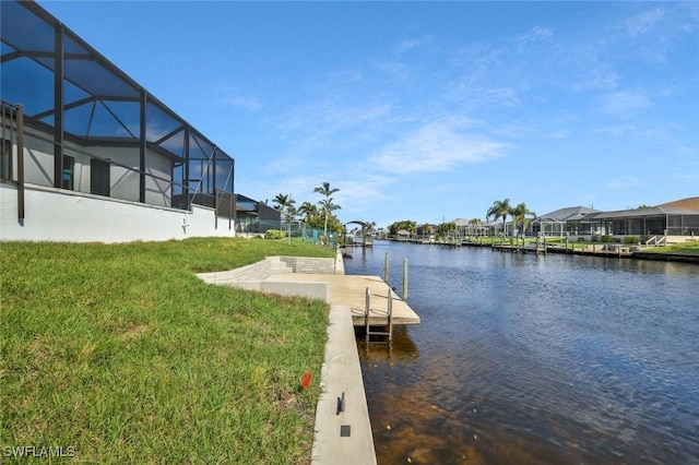 view of dock featuring a lanai, a residential view, a yard, and a water view