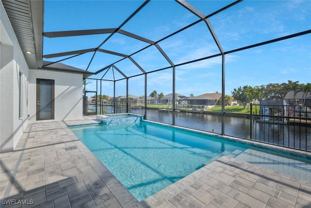 view of pool with a lanai, a patio area, a water view, and a pool with connected hot tub