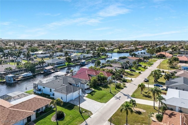 drone / aerial view with a residential view and a water view