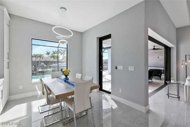 dining space featuring an inviting chandelier and baseboards