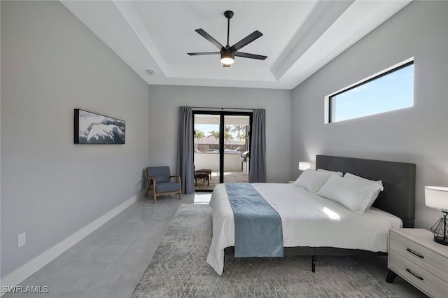 bedroom featuring visible vents, baseboards, a raised ceiling, a ceiling fan, and access to outside