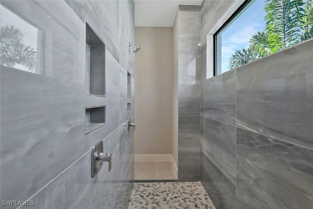 bathroom featuring tile patterned floors and tiled shower