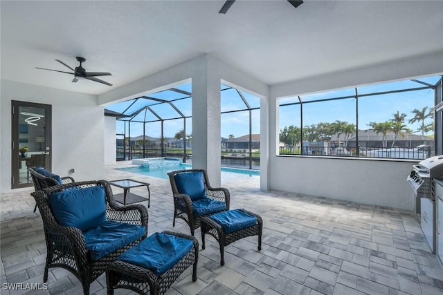 view of patio / terrace featuring glass enclosure, an outdoor pool, and ceiling fan