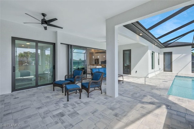 view of patio featuring glass enclosure, an outdoor pool, outdoor lounge area, and ceiling fan