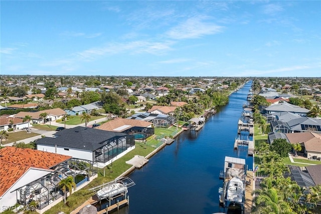 drone / aerial view featuring a residential view and a water view