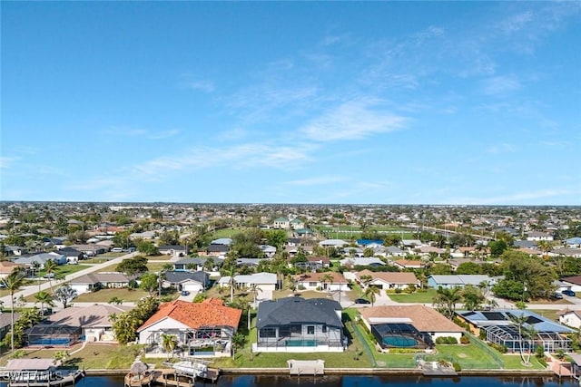 drone / aerial view with a residential view and a water view