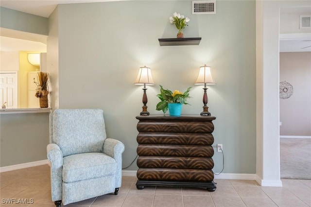 sitting room with baseboards, visible vents, and tile patterned floors