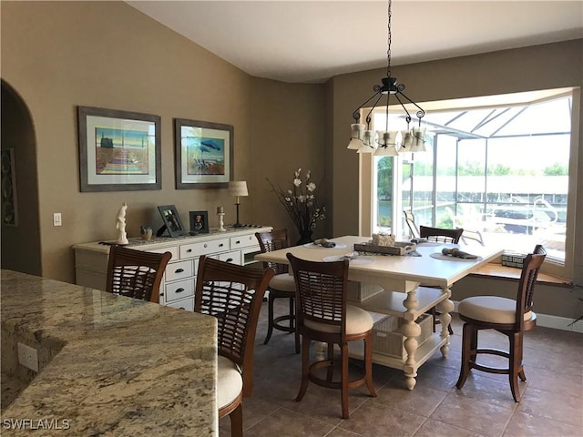 dining area featuring tile patterned floors and a notable chandelier