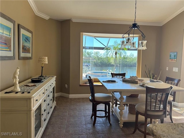 dining space with ornamental molding and baseboards