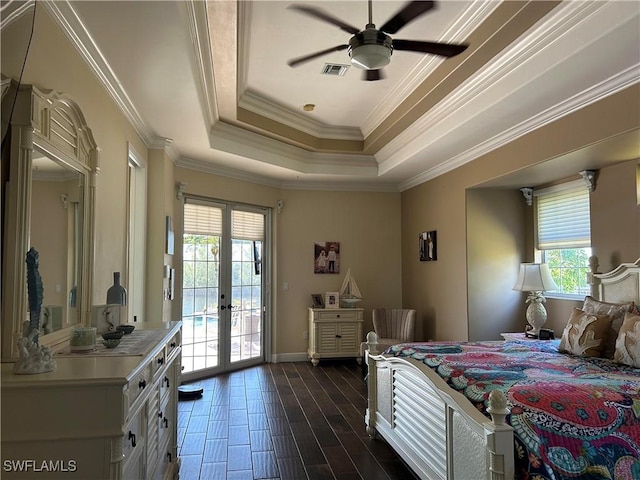 bedroom with visible vents, access to exterior, french doors, a tray ceiling, and dark wood finished floors