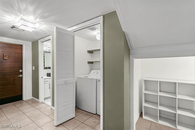 laundry room with light tile patterned floors, laundry area, and washer / dryer