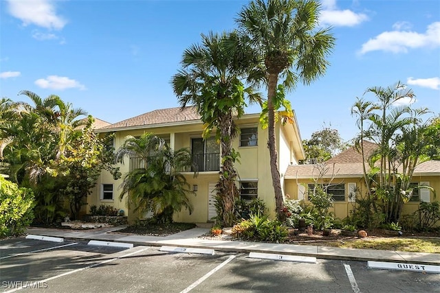 1201 Solana Rd Unit 3, Naples, FL 34103 - view of front of house featuring uncovered parking and stucco siding
