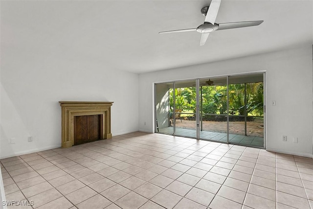 unfurnished living room featuring ceiling fan, light tile patterned floors, and baseboards