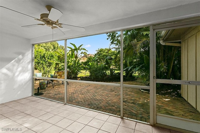 unfurnished sunroom with a ceiling fan