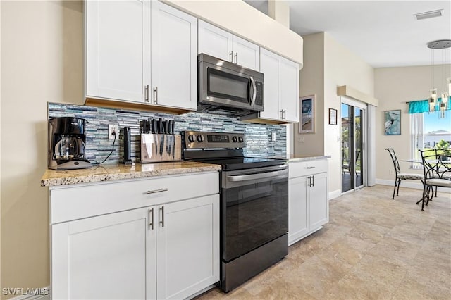 kitchen with decorative light fixtures, light stone counters, white cabinetry, appliances with stainless steel finishes, and decorative backsplash