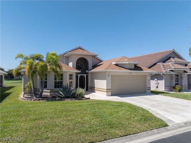 mediterranean / spanish home featuring stucco siding, concrete driveway, a front lawn, and a garage