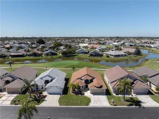 drone / aerial view featuring a residential view and a water view