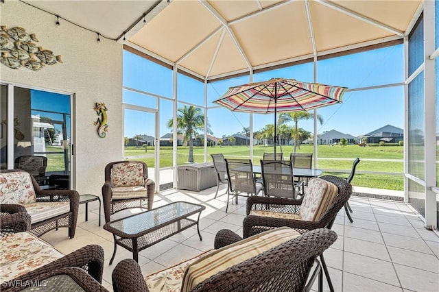 sunroom featuring a healthy amount of sunlight and a residential view