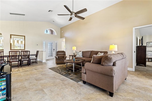 living room featuring ceiling fan, baseboards, visible vents, and high vaulted ceiling