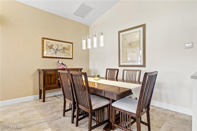 dining room featuring visible vents, baseboards, and vaulted ceiling