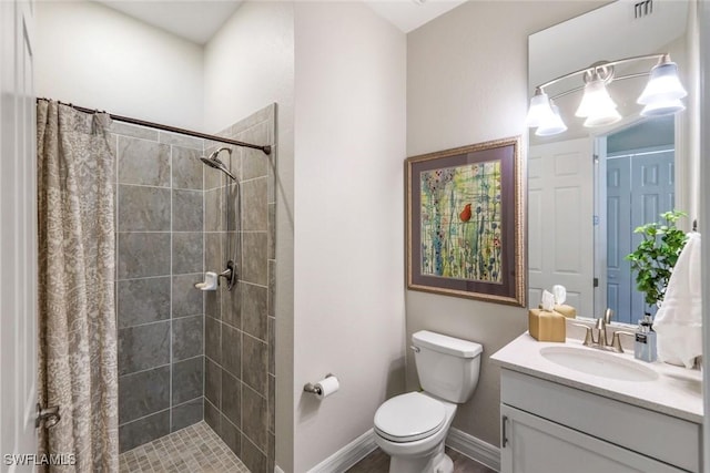 bathroom with visible vents, baseboards, toilet, a tile shower, and vanity