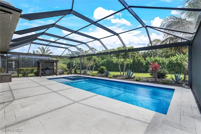 pool with glass enclosure and a patio