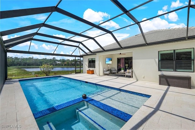 view of swimming pool featuring glass enclosure, a pool with connected hot tub, a patio area, and ceiling fan