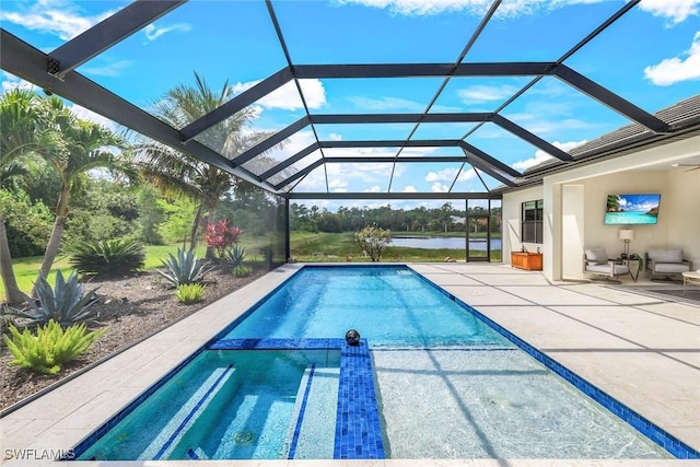 view of pool with a patio area, a lanai, and a pool with connected hot tub