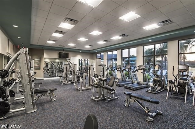 exercise room featuring a paneled ceiling and visible vents