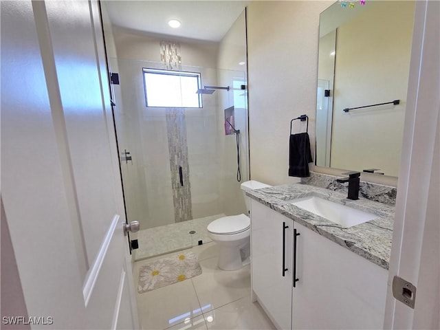 full bathroom featuring toilet, a shower stall, vanity, and tile patterned floors