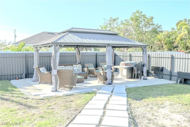 view of patio featuring a fenced backyard, an outdoor hangout area, and a gazebo