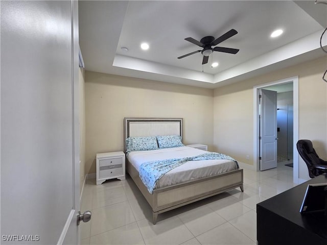 bedroom with baseboards, a tray ceiling, light tile patterned floors, and recessed lighting