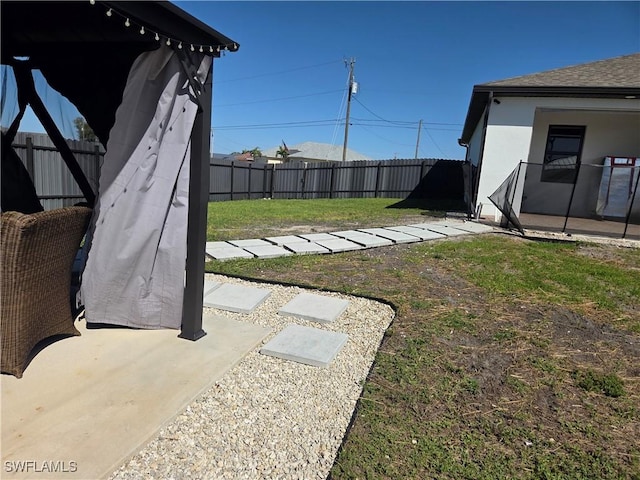 view of yard with a fenced backyard and a patio